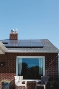 brown brick house with solar panels