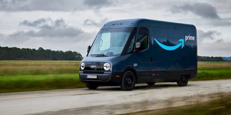 An Amazon Prime electric delivery van, made by Rivian, driving down a rural road, symbolizing the expansion of electric last-mile delivery.