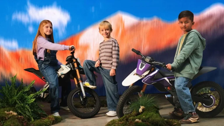 A small, sleek electric dirt bike for kids in purple with knobby tires and a high front fender.